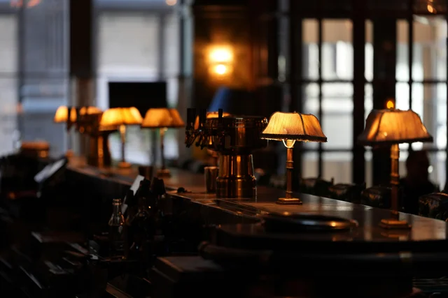 Row of elegant lamps illuminating a bar counter