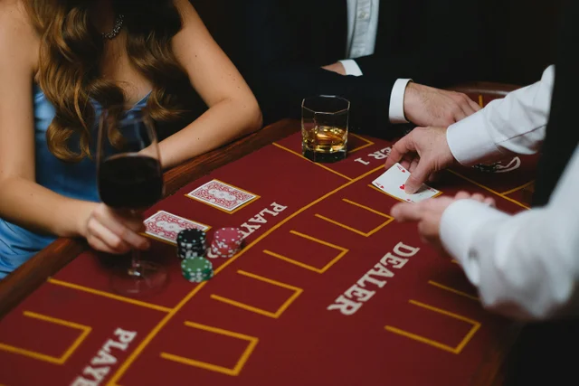 People gathered at a casino table with cocktails