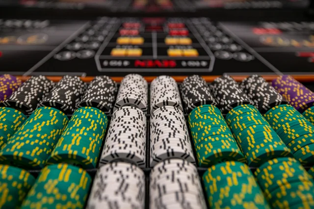 Colorful casino chips on a green felt table