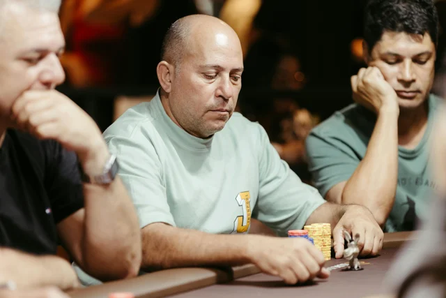 Men focused on a poker game at a casino table