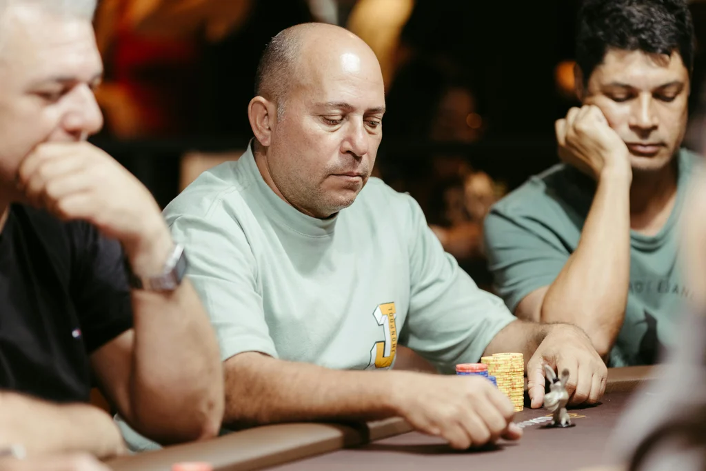 Men focused on a poker game at a casino table