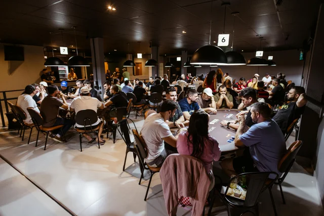 Multiple players in a lively poker game at a casino