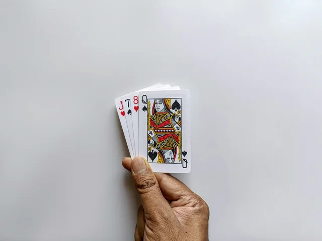Hand holding a small stack of playing cards