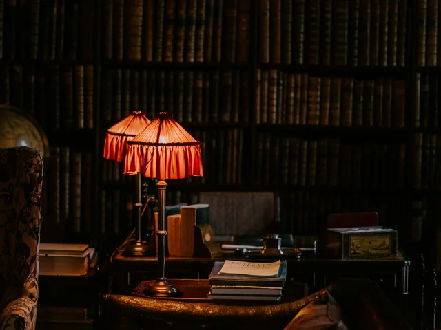 Warm table lamps glowing in a library setting