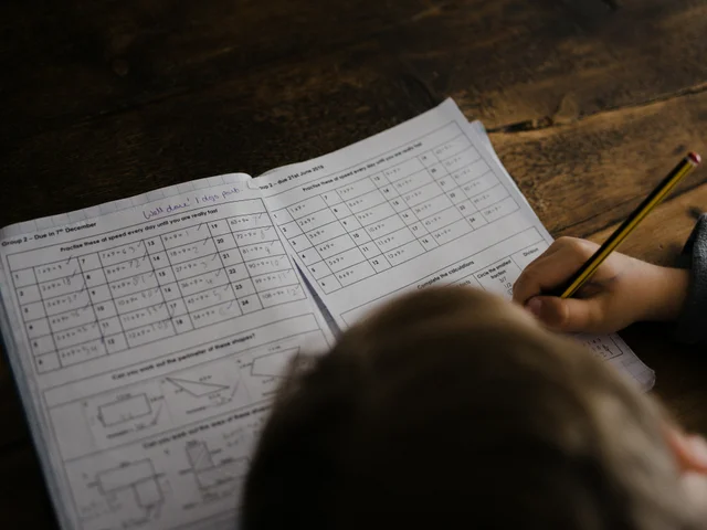 Student focused on writing notes at a desk