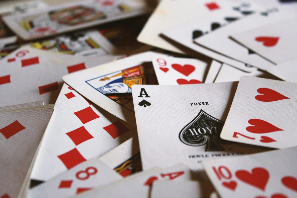 Scattered playing cards on a green table