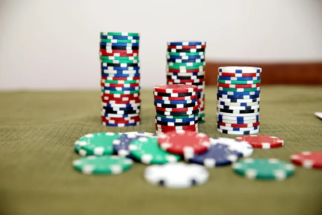 Colorful poker chips stacked on a green felt table